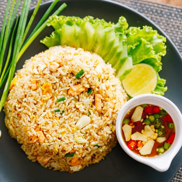 Yin Yang Express's chicken fried rice with lime, lettuce, green onions, and chili sauce.